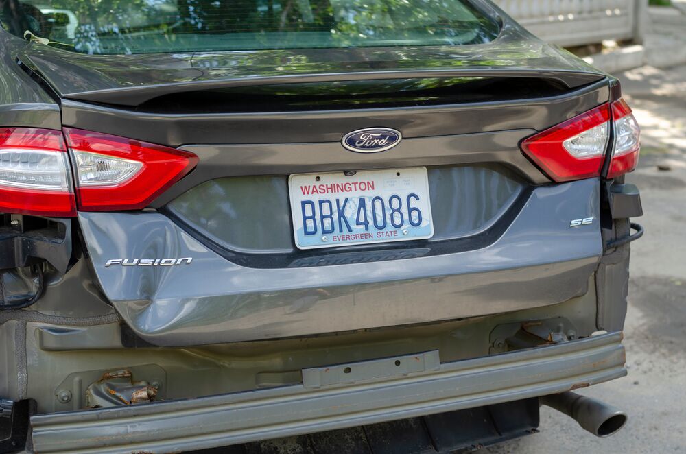 Odessa, Ukraine - June 17, 2020: Ford Fusion car with a damaged rear end. Gray sedan with American registration in Washington state. Traffic incident, insurance.